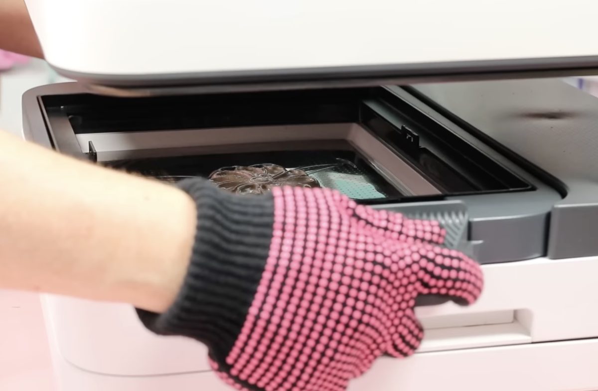 Hold the handles of the vacuum forming module in place.