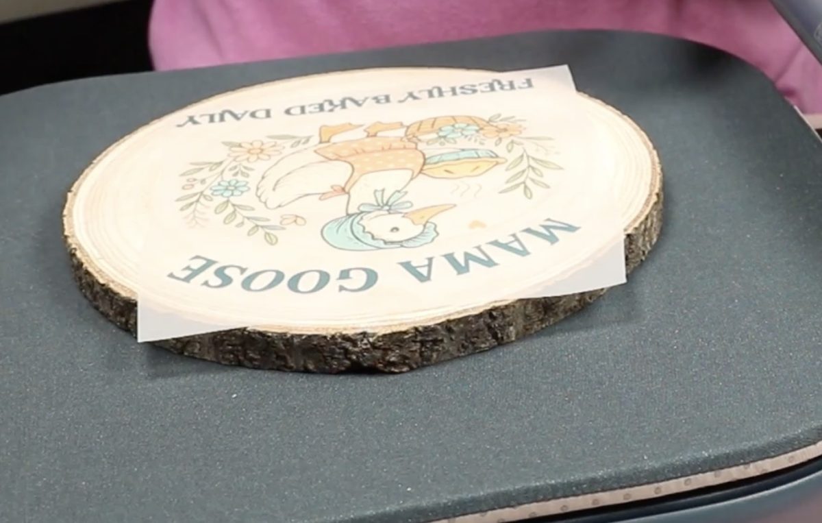 Locate the DTF design on the wood round.