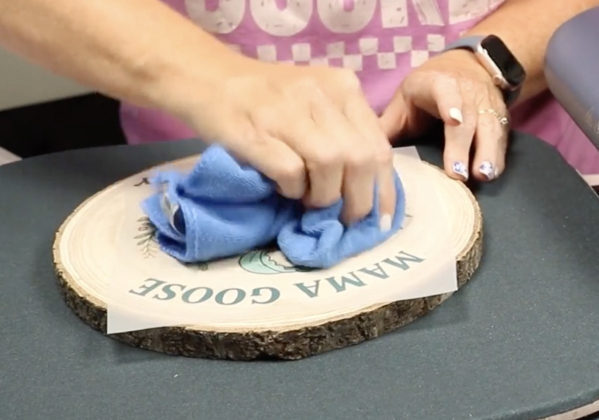 Use a microfiber cloth to press the DTF into the wood.