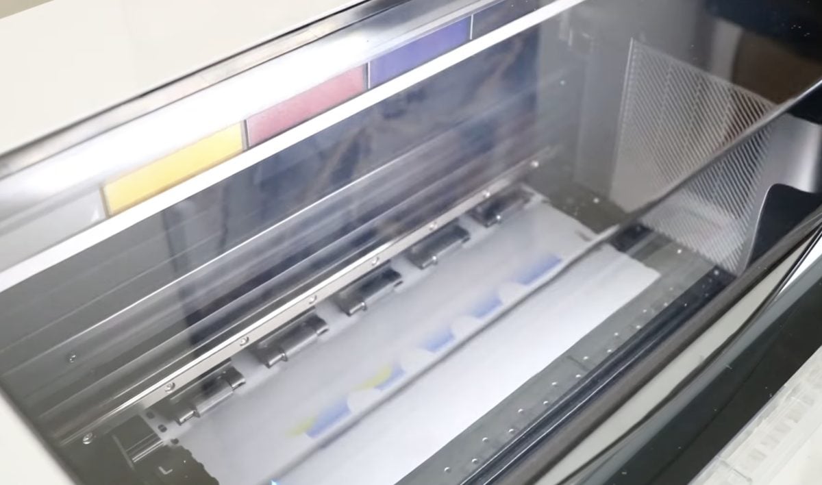 xTool Apparel printer printing a DTF image.