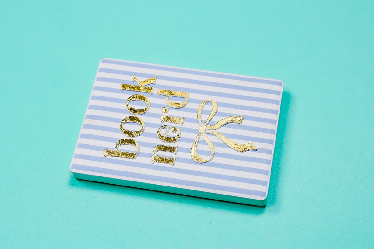 Finished gold foil white ceramic magnet.