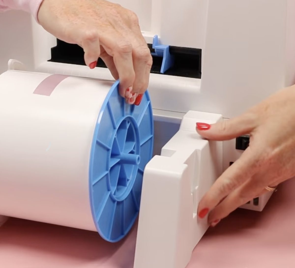 Add blue wheel to the roll of sticker media.