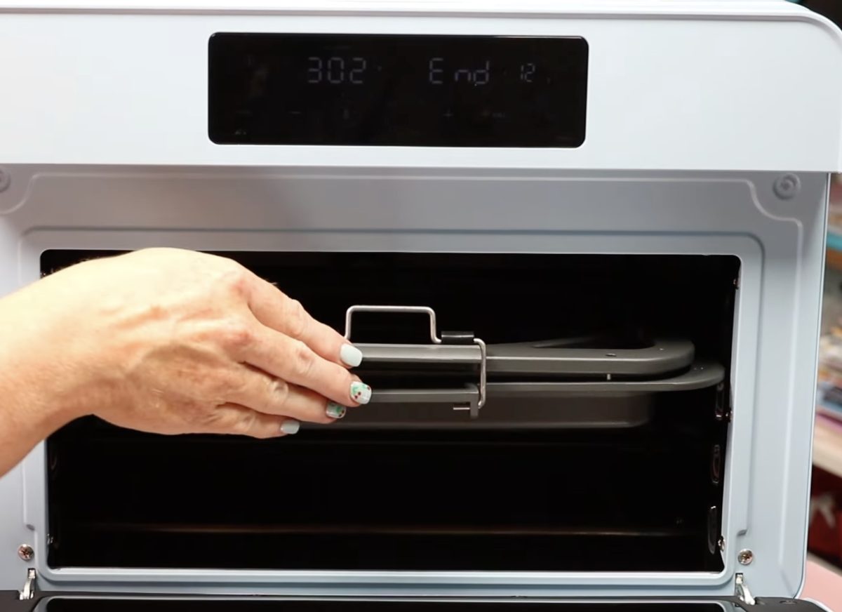 Place the tray in the oven flat against the back of the oven.