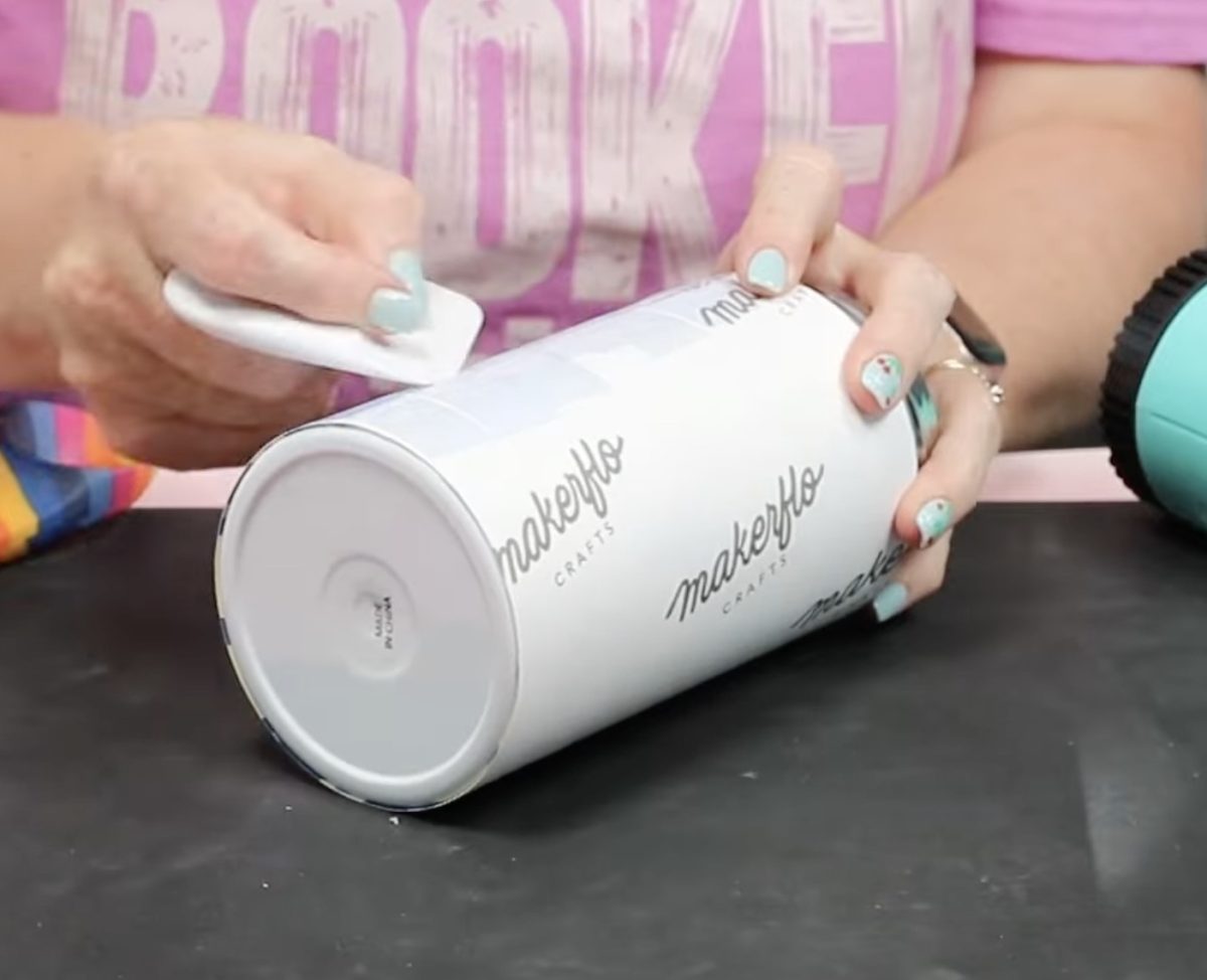 Press the tape down with a scraper tool.