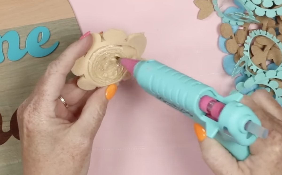 Use hot glue to secure the felt rolled flower.