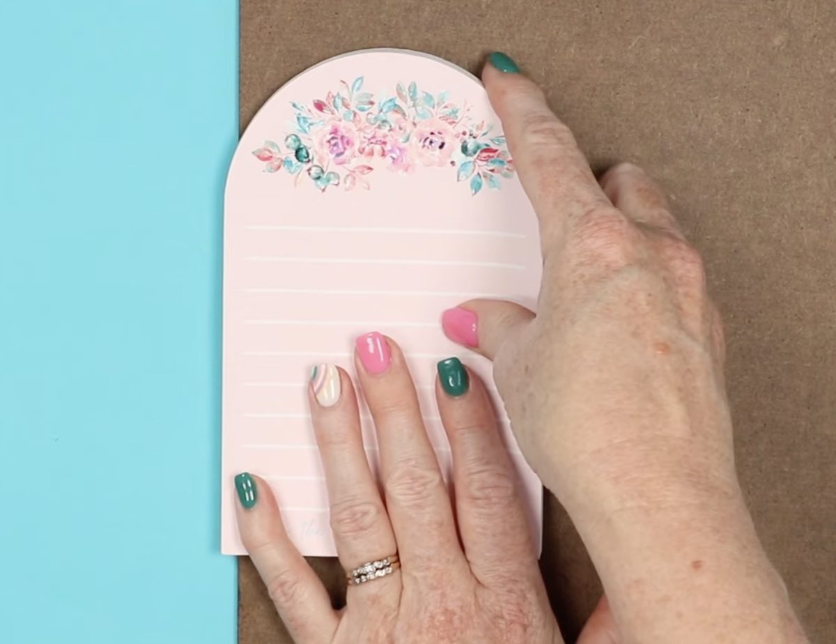 Add a board to the bottom and top of the notepad.