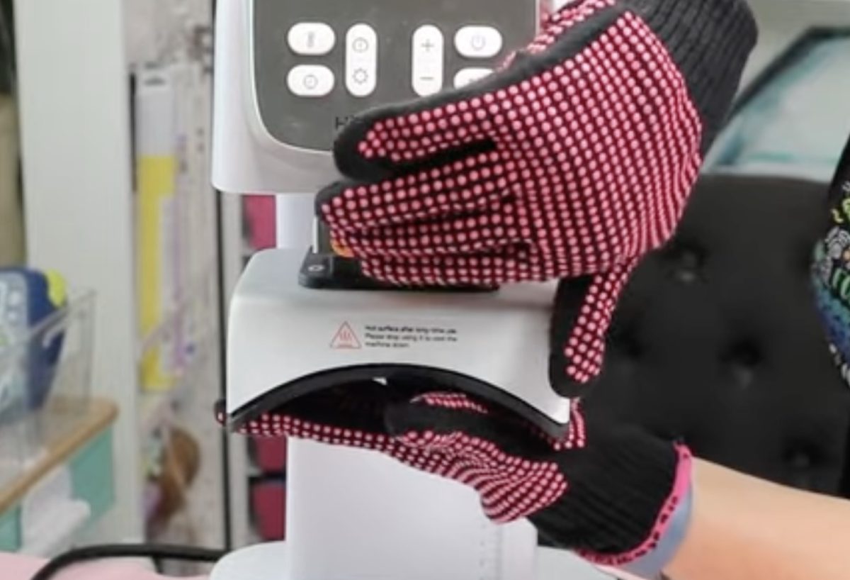 Remove the top of the hat press with heat-resistant gloves.