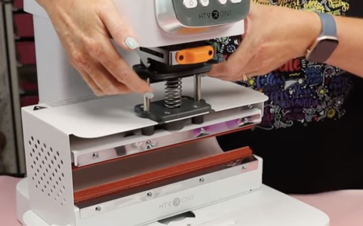 Raise the top of the tumbler module into the A100 press.