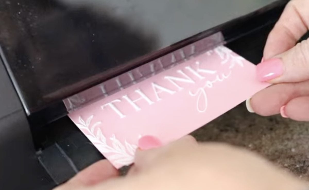 Feed the printed card through the laminator.
