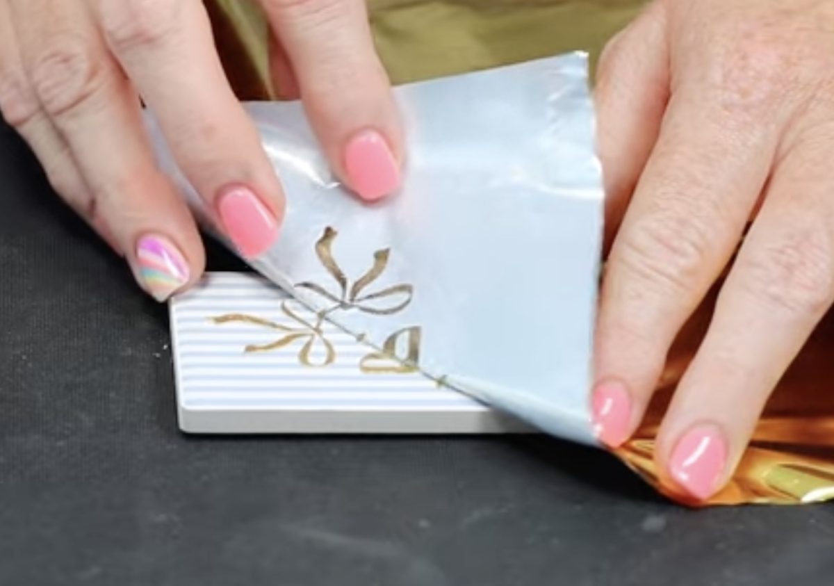 Peel the foil away from the ceramic magnet.