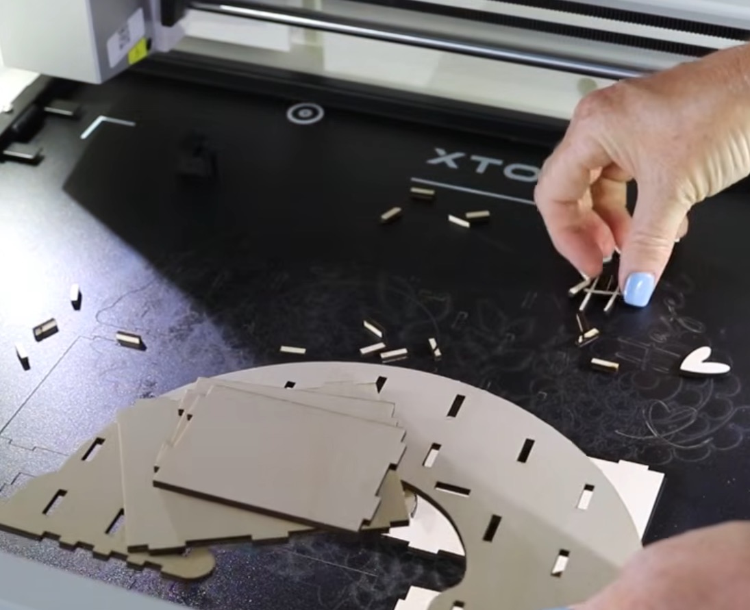 Remove cut pieces and excess wood from the laser bed.