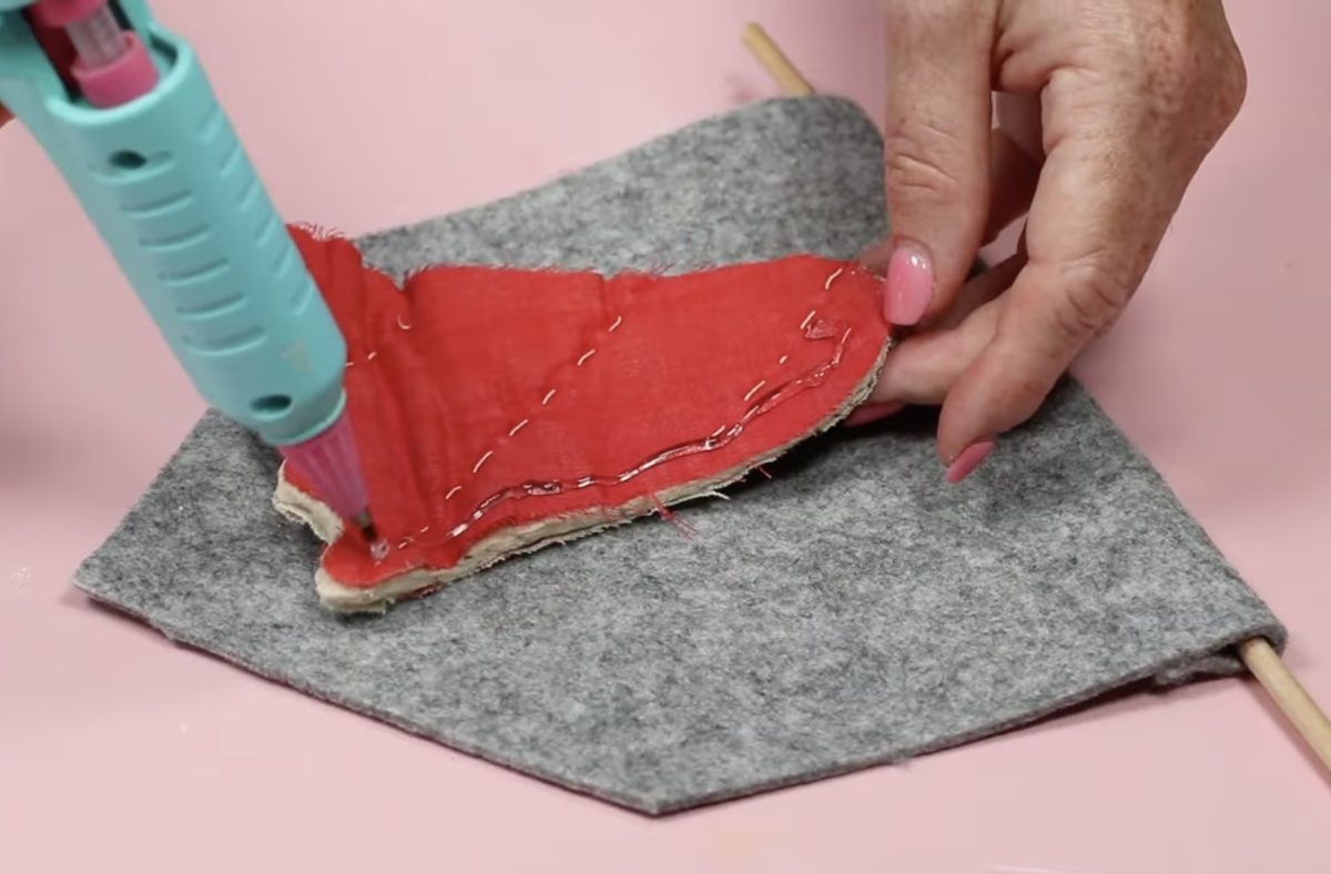 Secure quilt ghost to felt flag with hot glue.