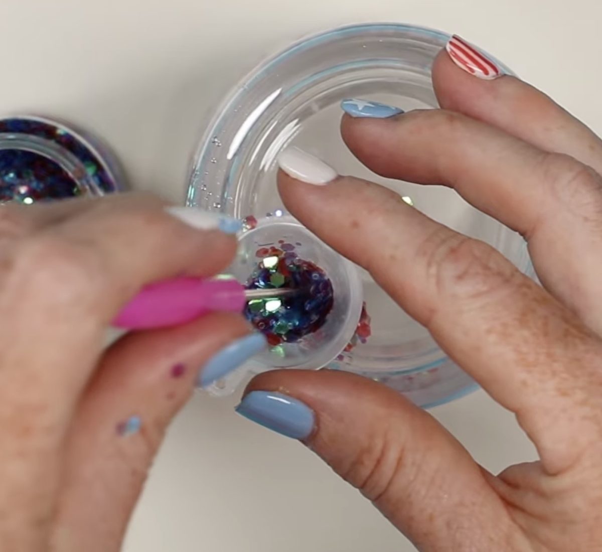 Use a funnel and pointed tool to add the glitter to the tumbler.