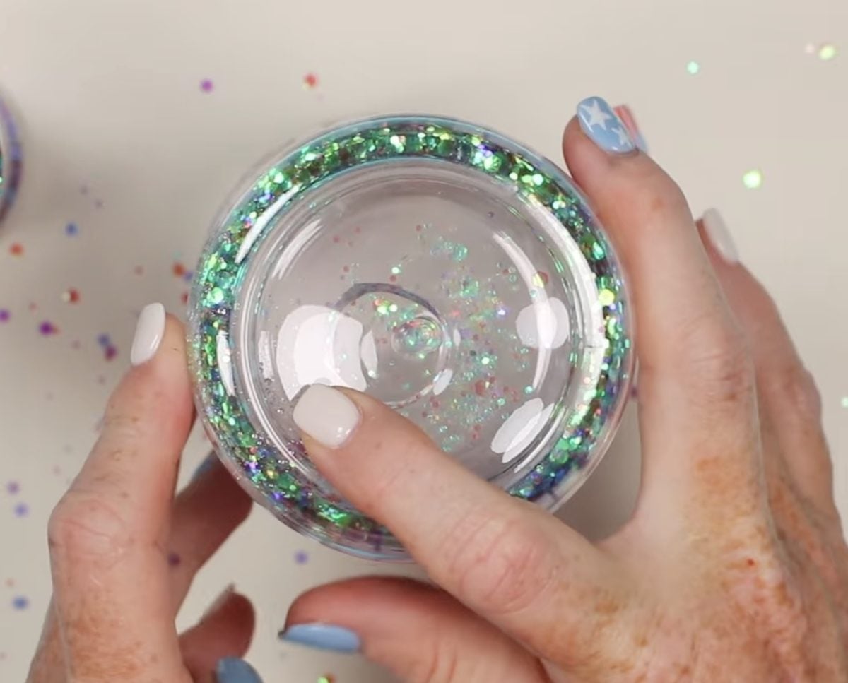Use a finger to close the hole and check glitter.