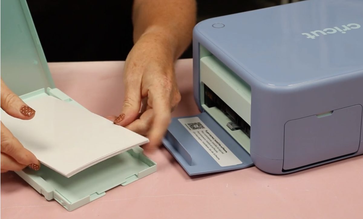 Load the photo paper into the material tray.