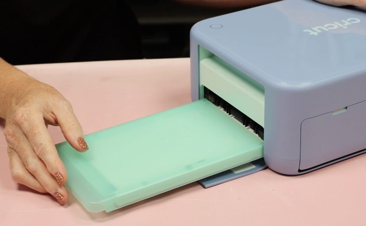 Load the material tray into the machine.