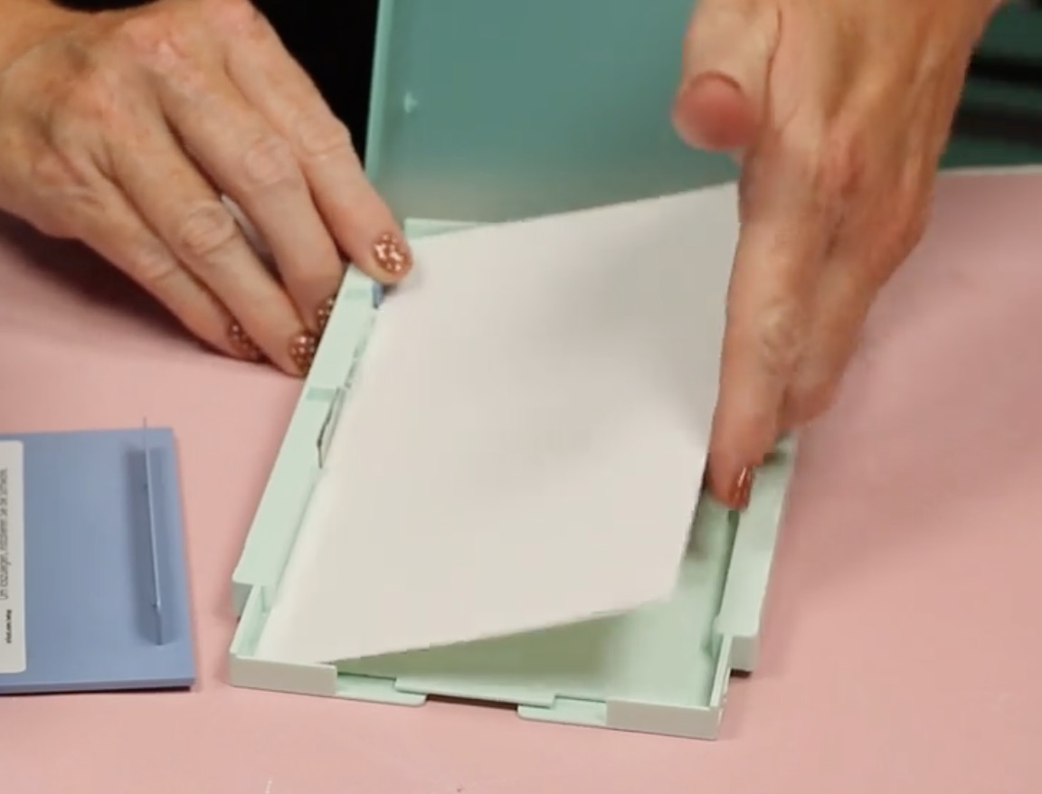 Load the sticker paper into the material tray.