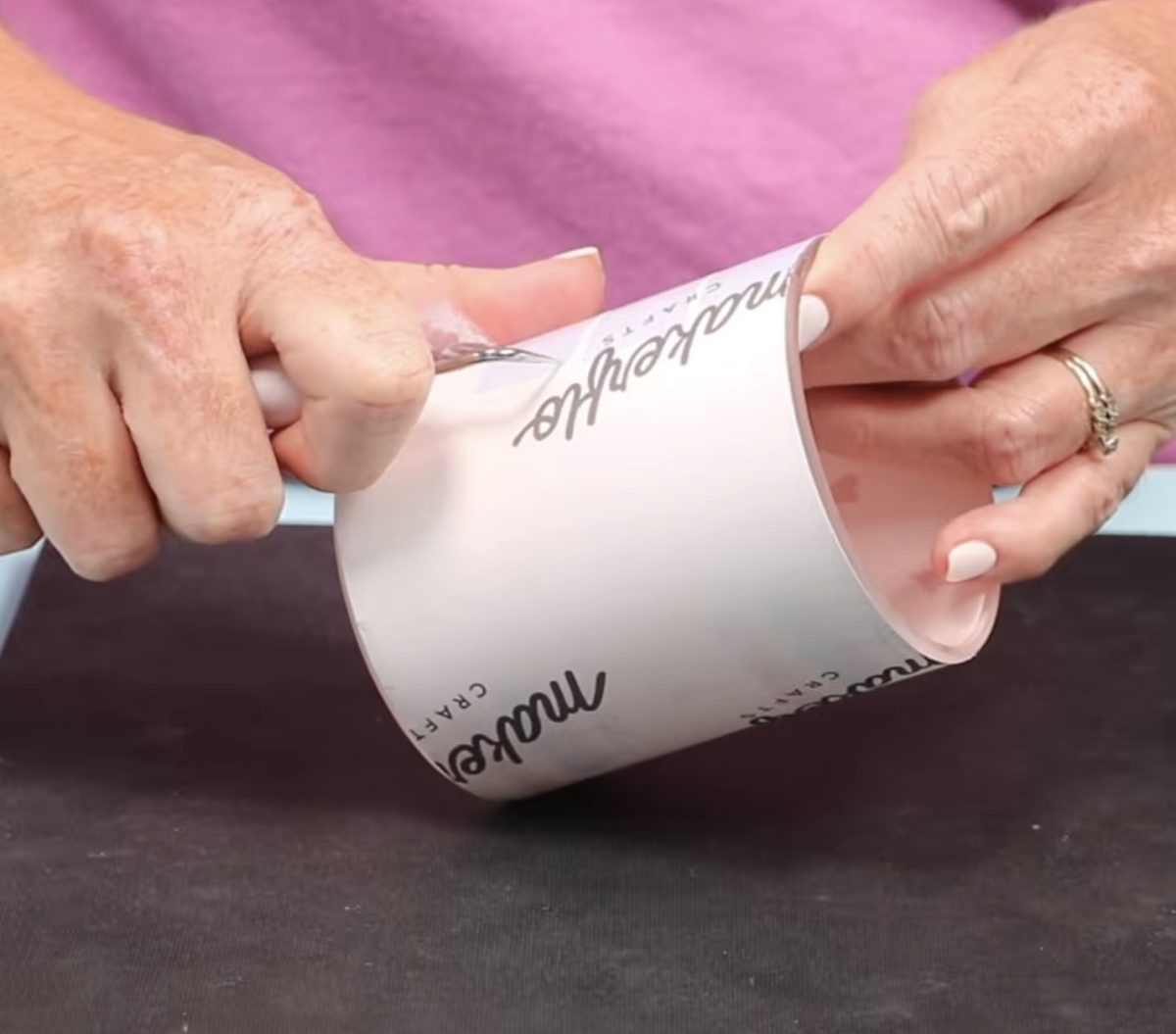 Remove the sublimation print from the candle jar.