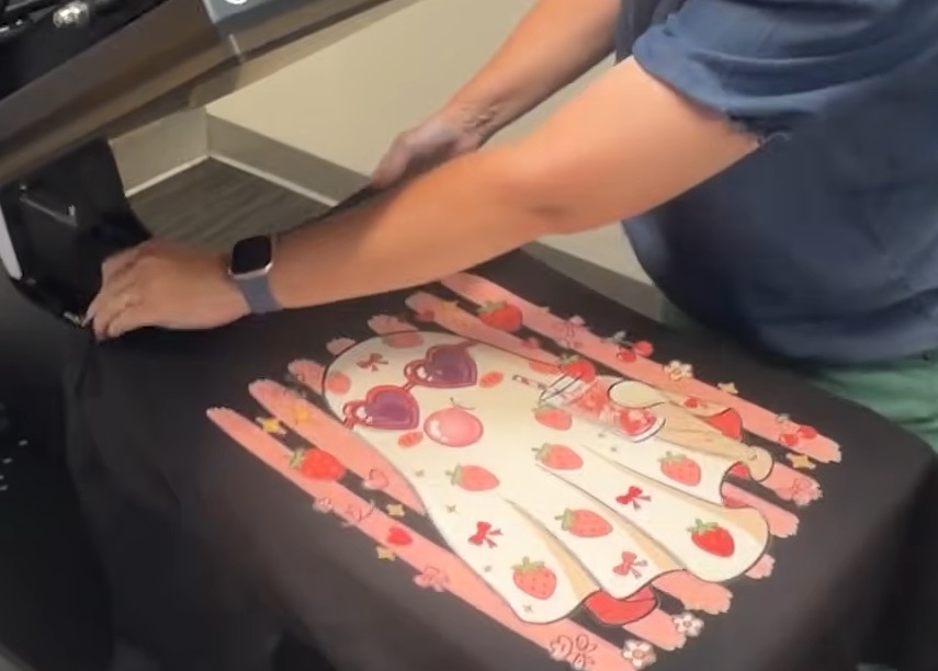 Load DTG printed shirt onto the heat press.