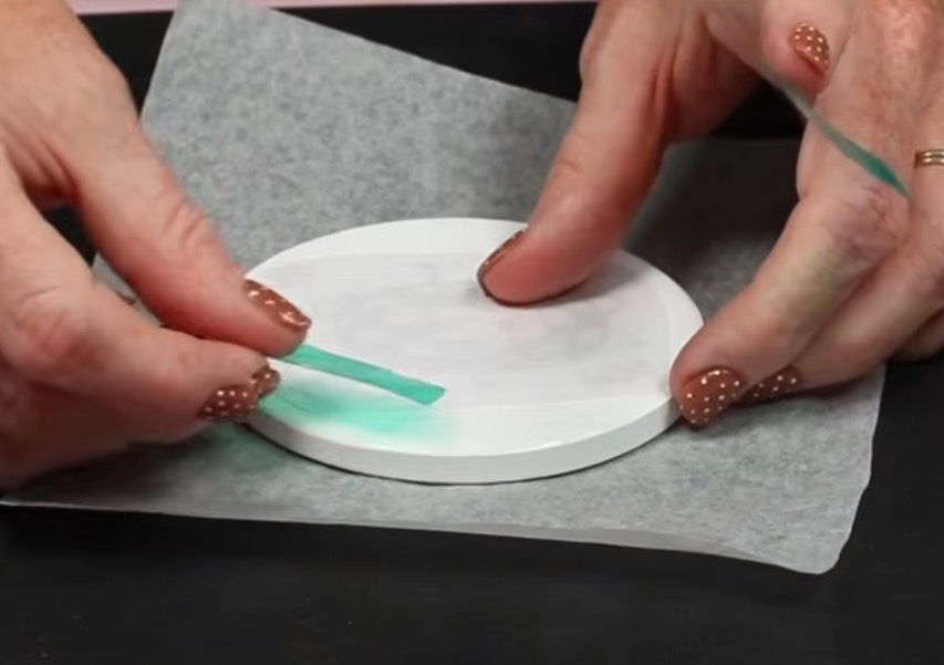 Secure sublimation print on ceramic coaster with heat-resistant tape.