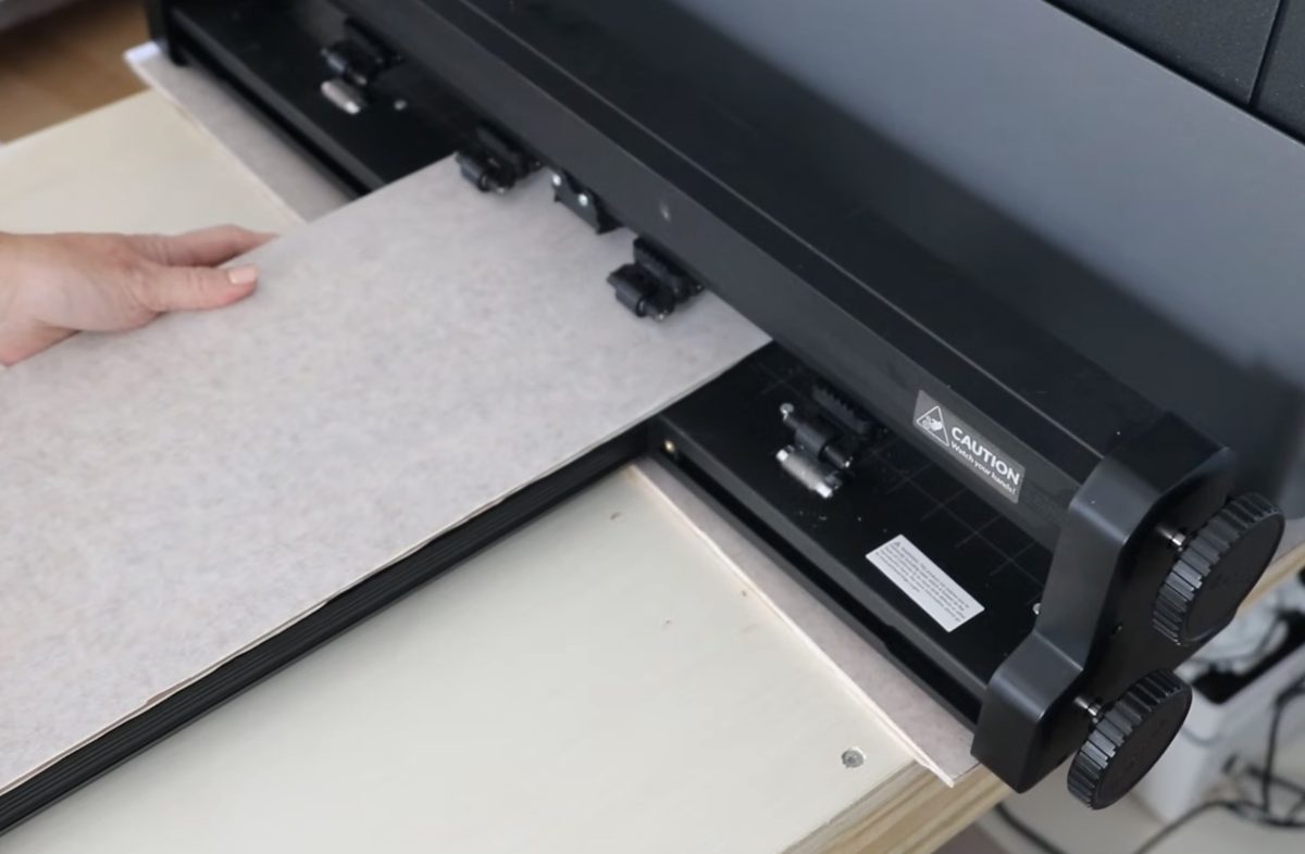 Load the material into the pass-through tray.