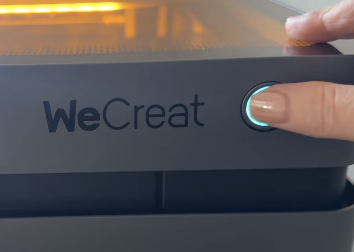 Press the button on the front of the laser to start the process.