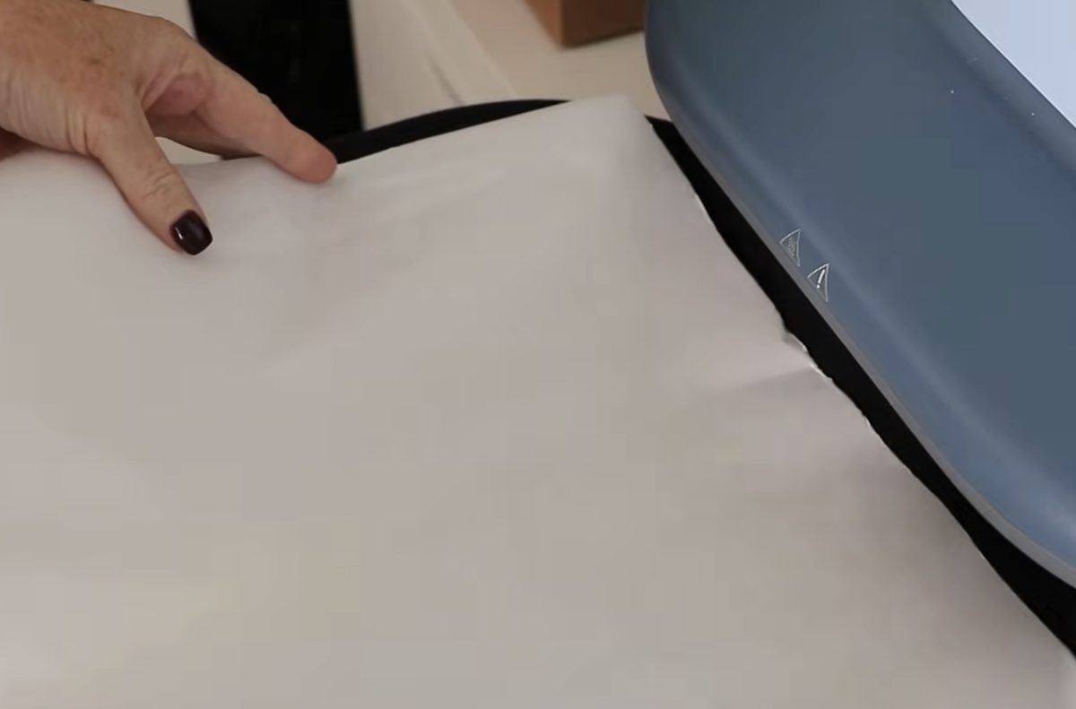 Cover the DTG shirt with protective paper.